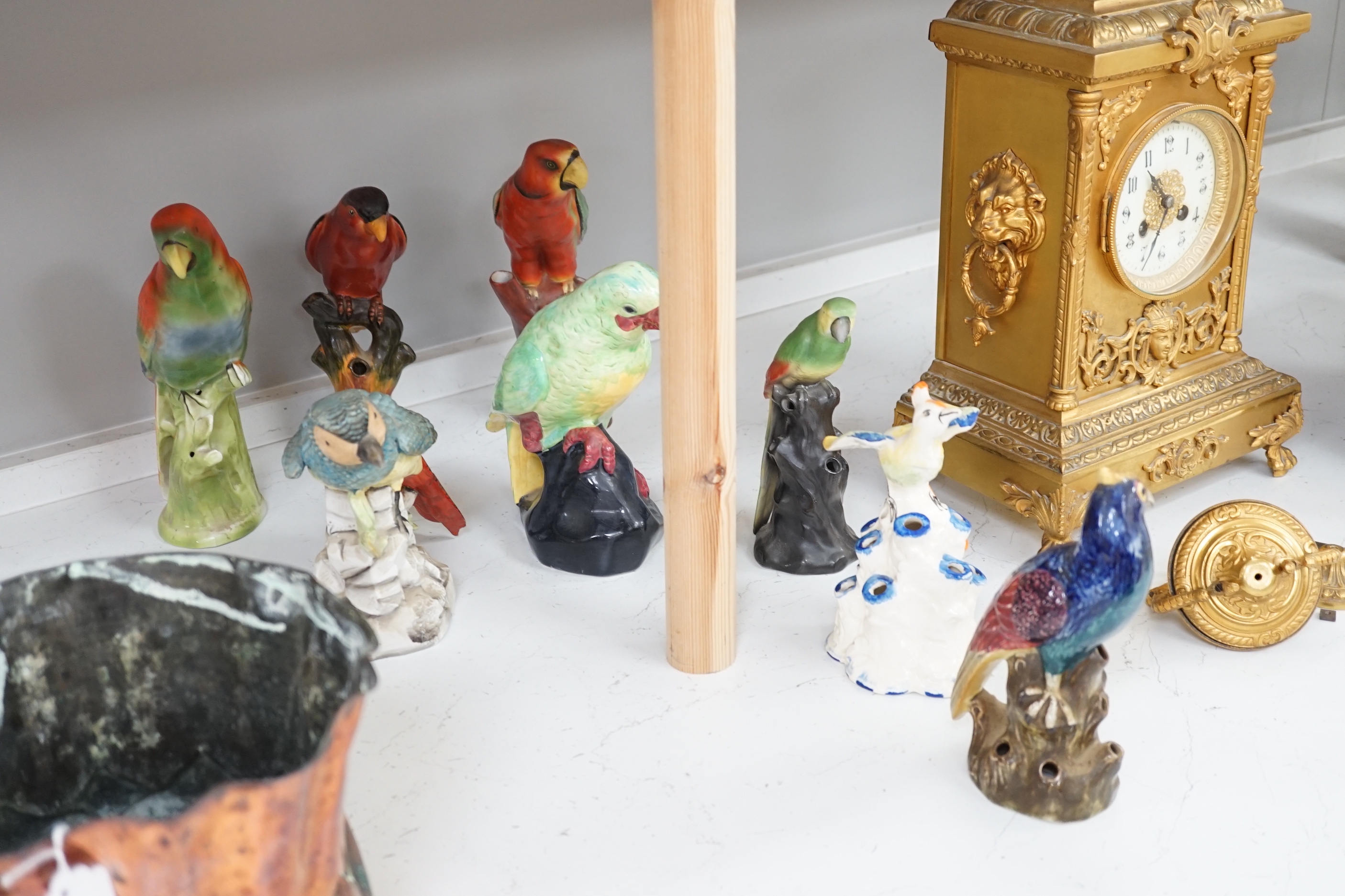 A group of twelve ceramic parrots including one by S Hancock & Sons, largest 24cm high